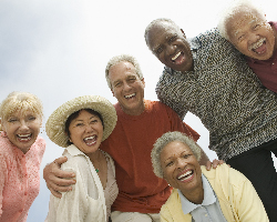 A group of older adults smiles down at the camera.